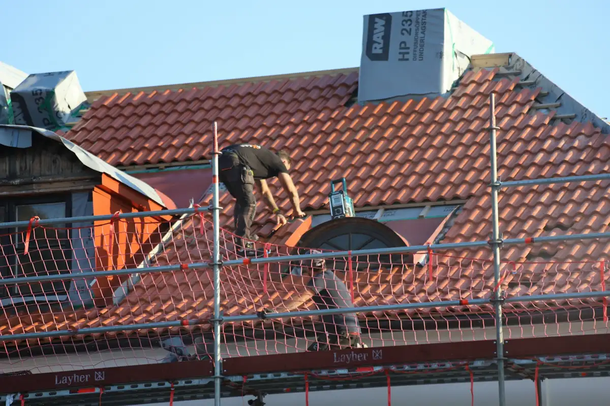 Roofer repairing a section of roof