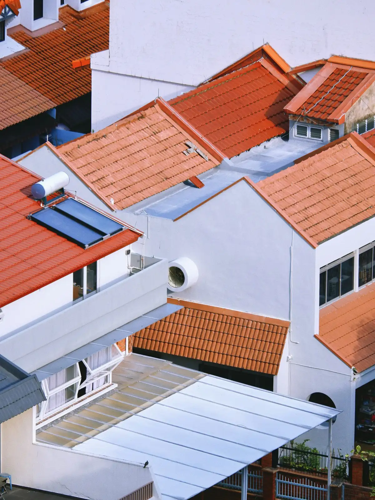 Tile rooftops of residential homes in the sun